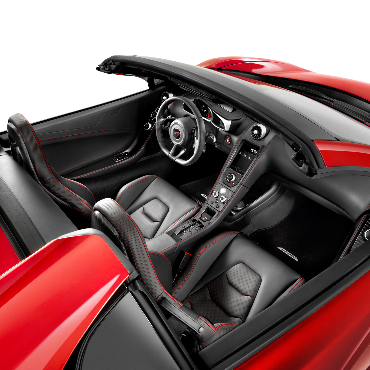 Interior of a red McLaren 12C Spider, photographed in a bright white studio environment.
