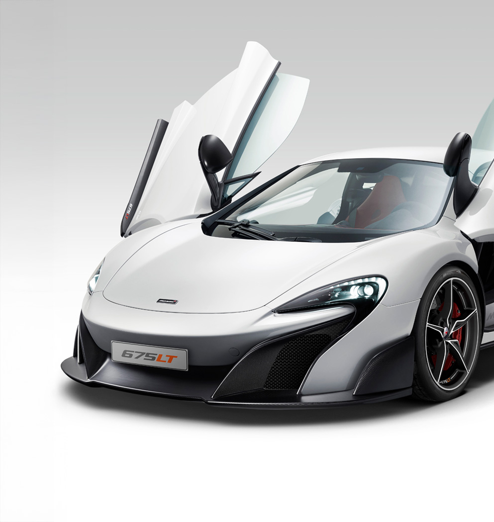 The front of a white McLaren 675LT with its dihedral doors open.