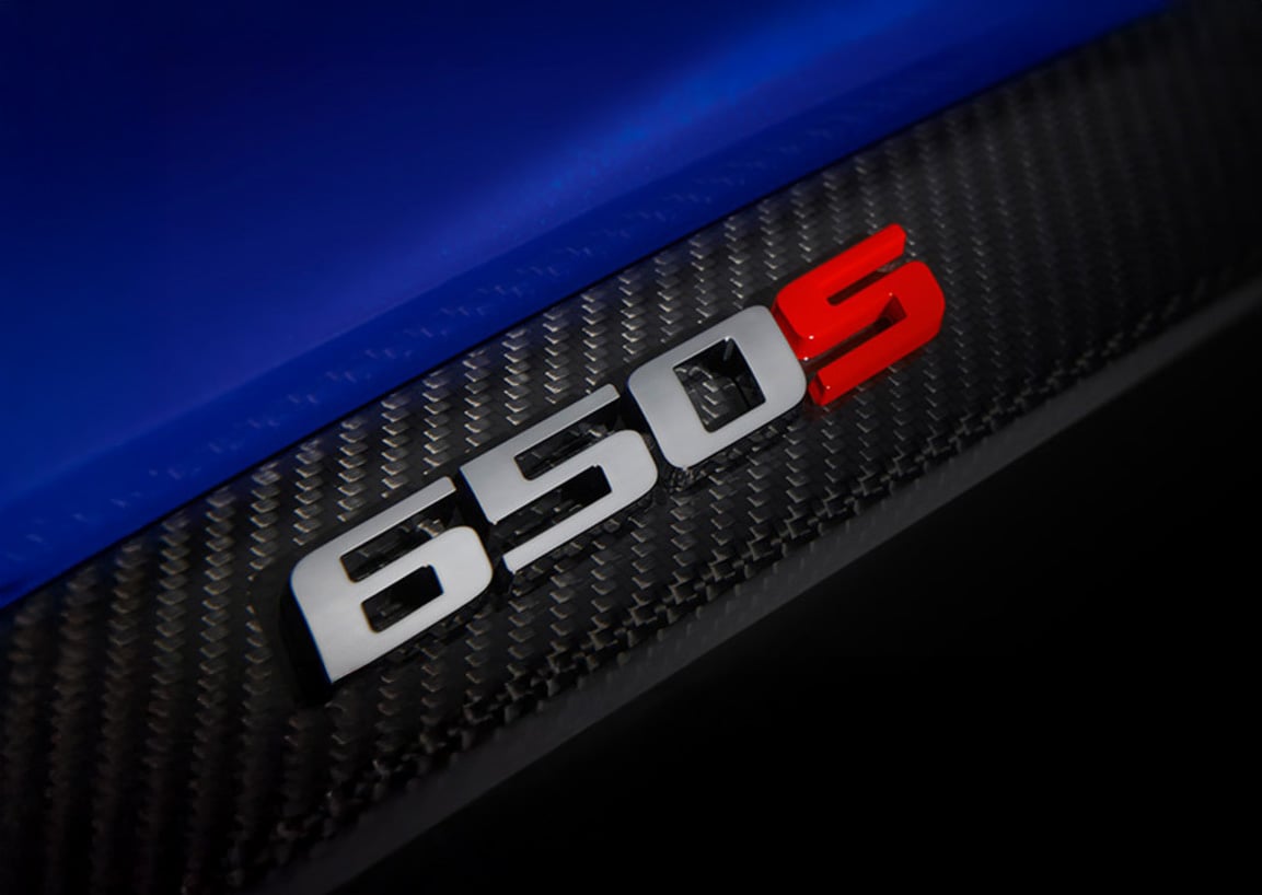 Close up of a McLaren 650S badge on the car body.