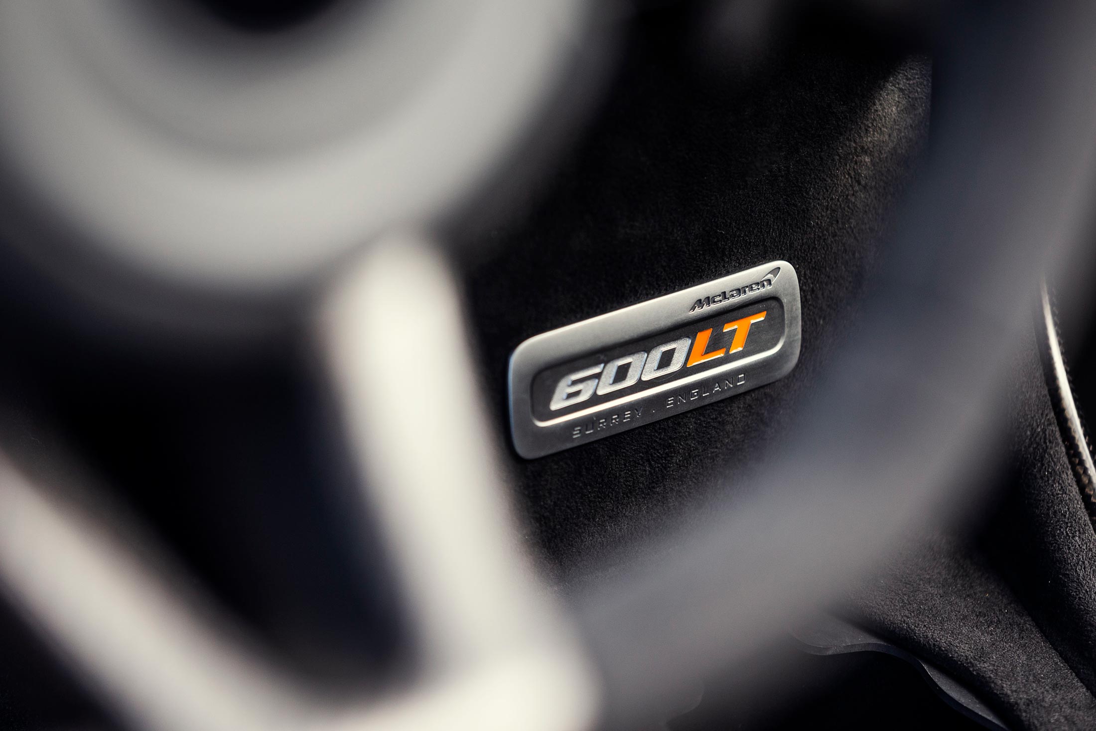 McLaren 600LT interior nameplate with Surrey, England engraving, highlighting exclusivity and precision engineering