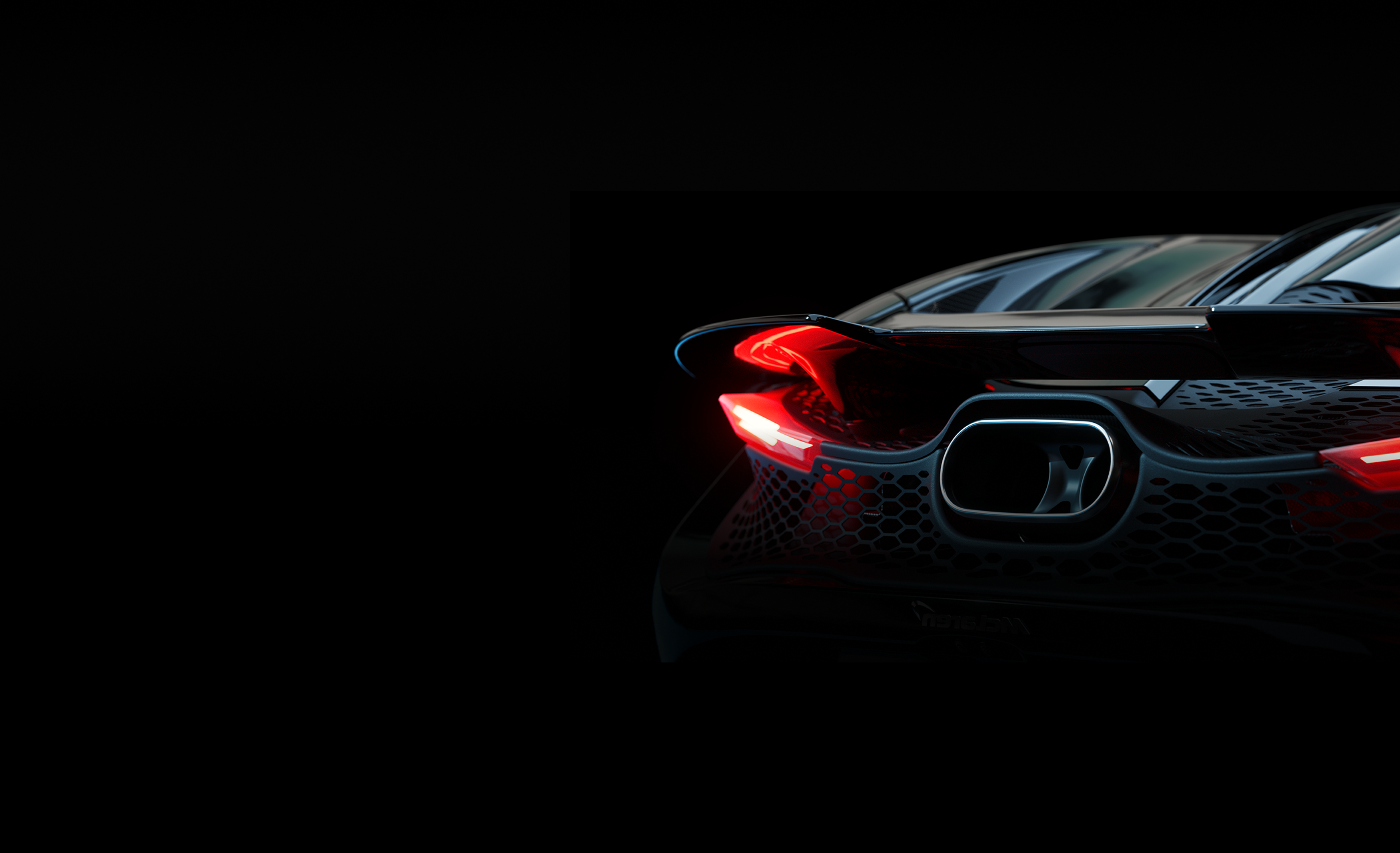 A wide banner image showing the rear of a black McLaren 750S supercar in the dark, highlighting the glowing red taillights and a prominent single exhaust pipe.