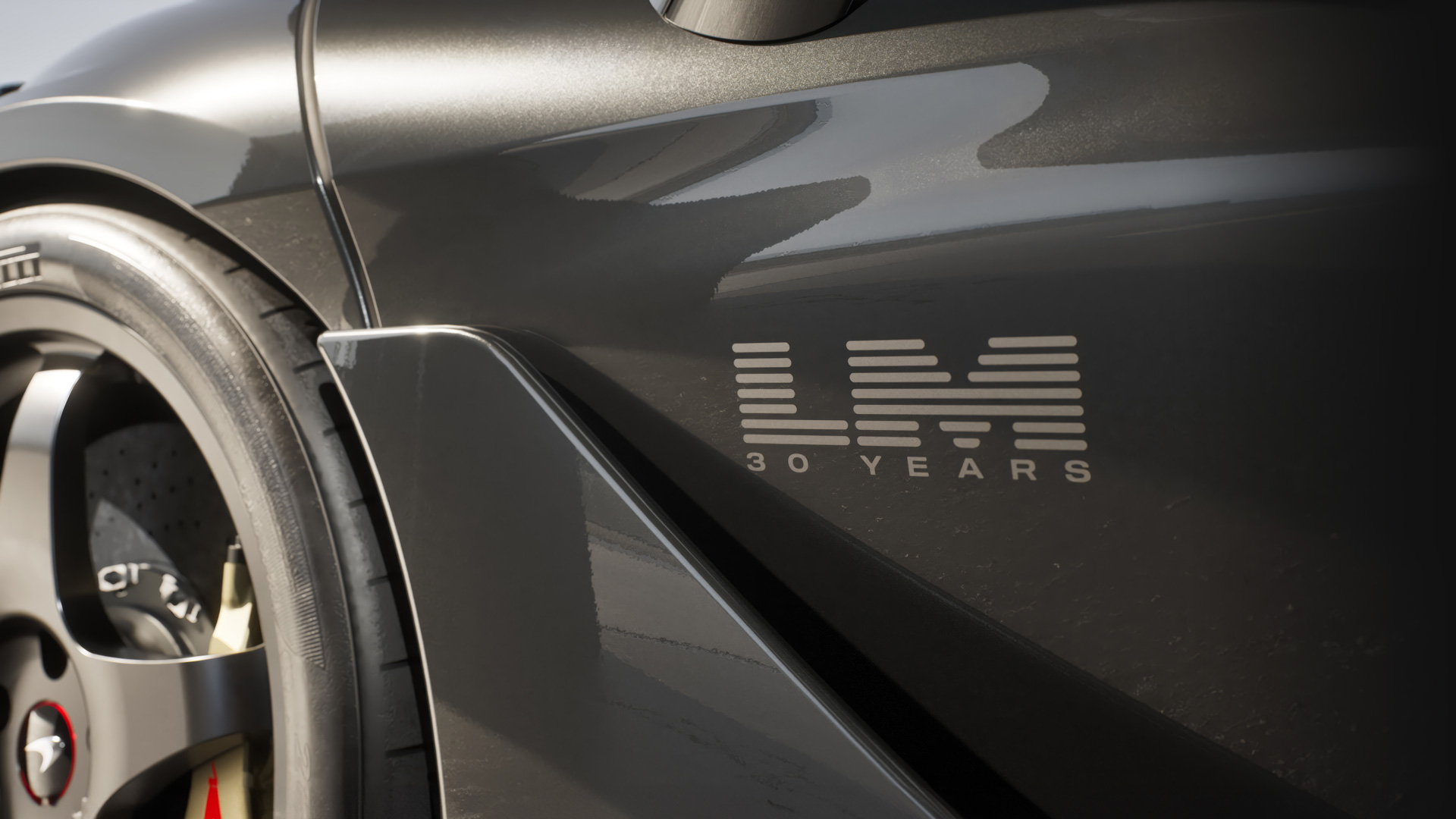 A detail shot of a grey McLaren 750S's side panel, featuring the exclusive 'LM 30 YEARS' logo, celebrating the 30th anniversary of McLaren's Le Mans victory.