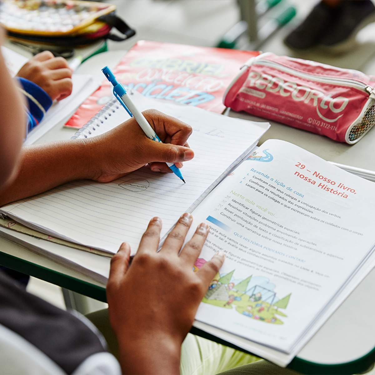 A child working in a school workbook.