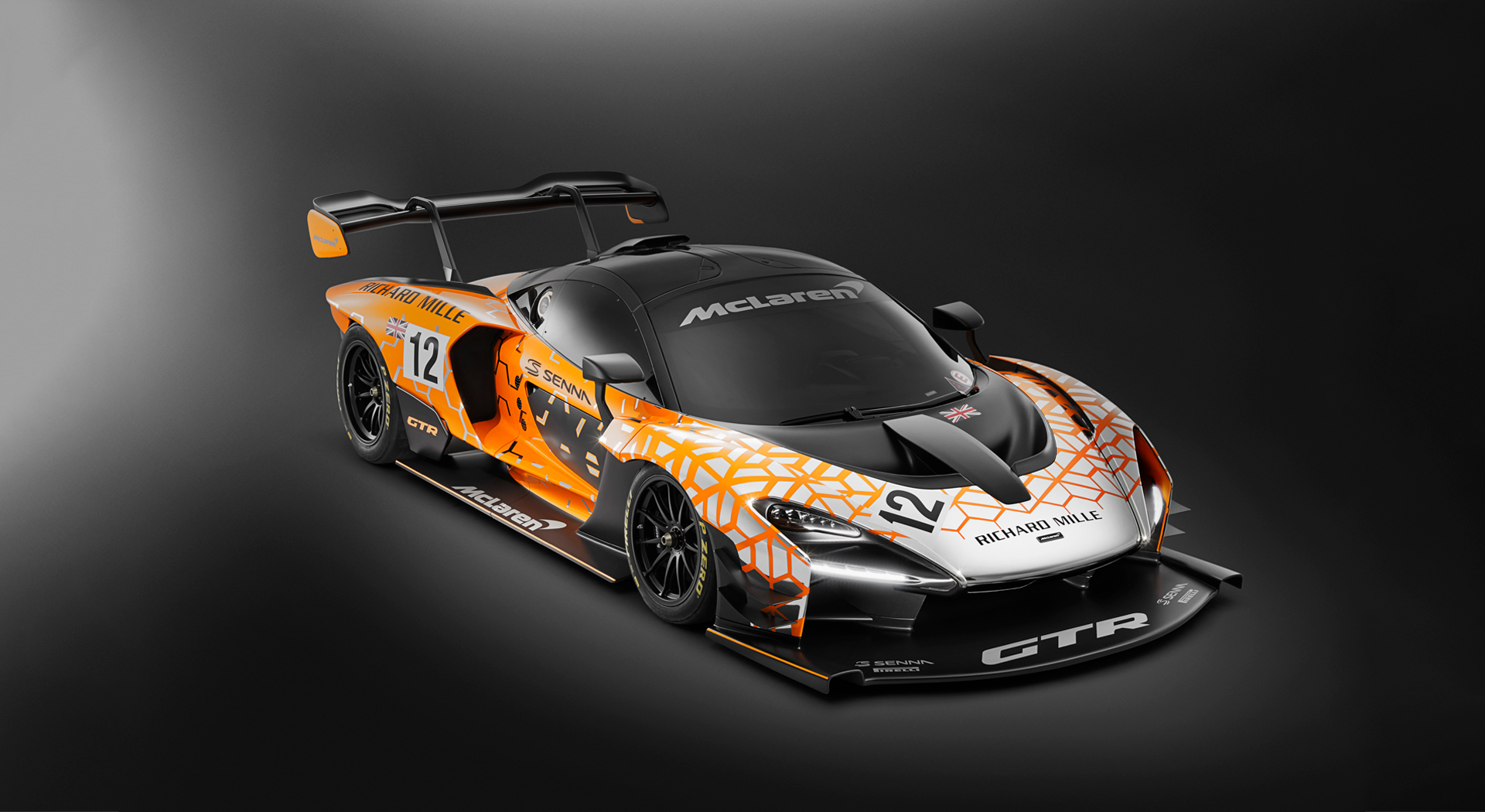 Front three quater passenger side view of the McLaren Senna GTR Concept car, photographed in a dark studio environment.