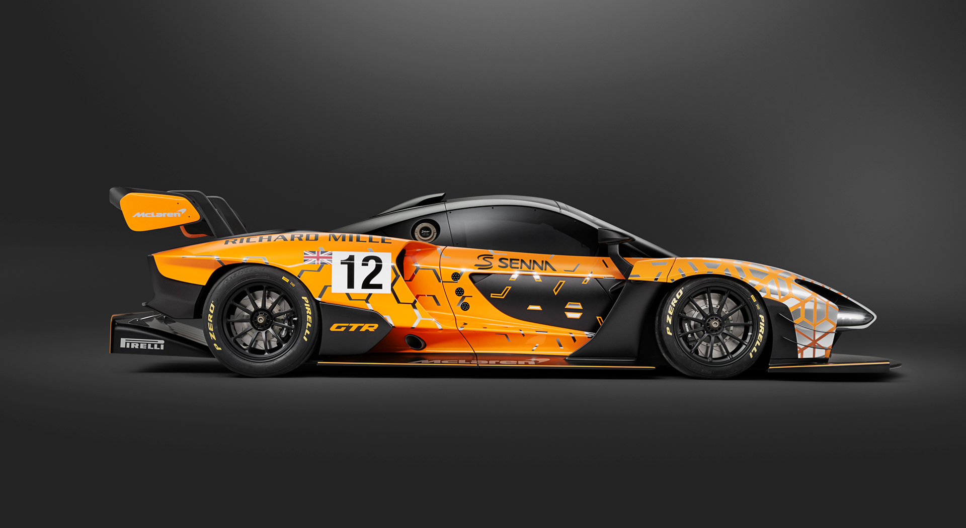 Side view of the McLaren Senna GTR Concept car, photographed in a dark studio environment.