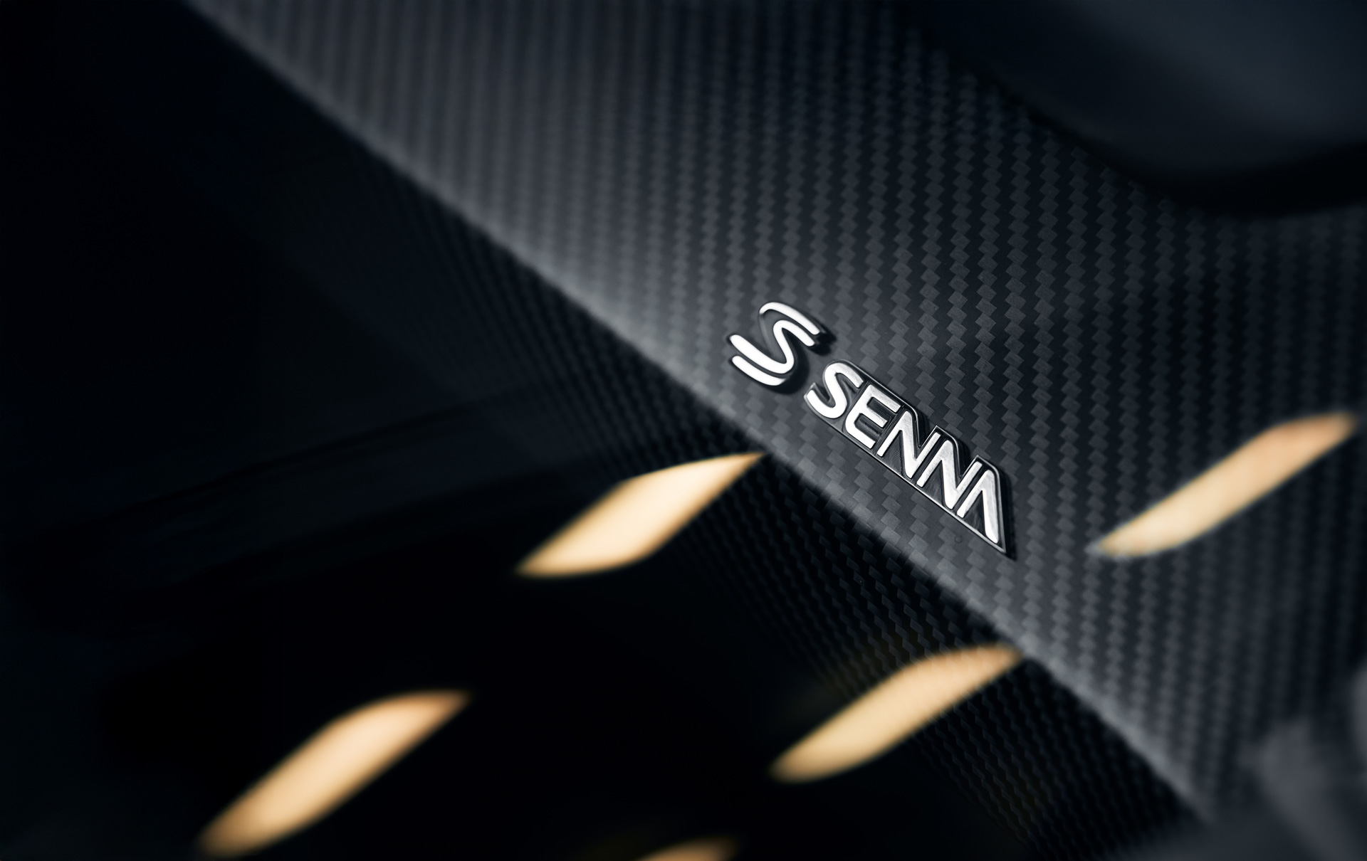 Close up of the Senna badge on the carbon fibre body of the McLaren Senna.