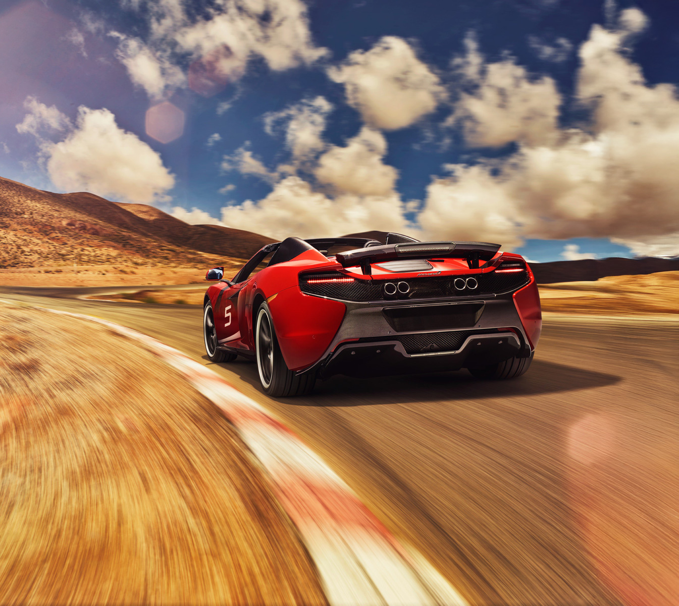 McLaren 650S CAN-AM Spider driving down a winding desert road.