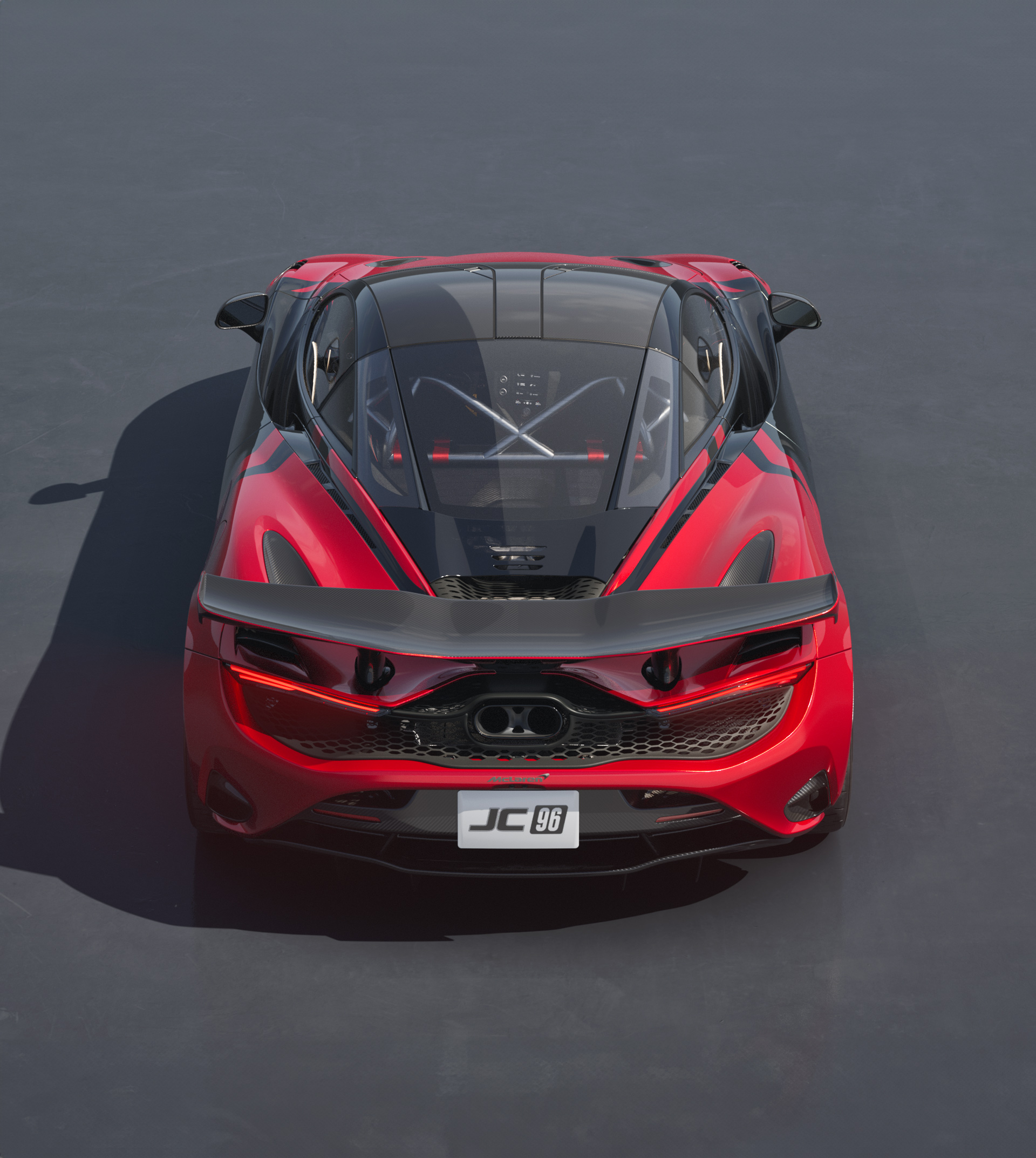 Top-down rear view of the McLaren 750S JC96 tribute car, featuring a red and black livery and large rear wing.
