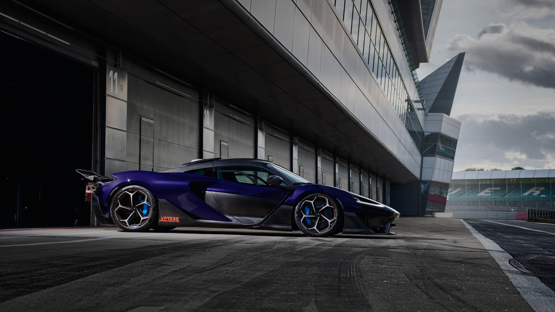 A shot of the side of a McLaren W1 prototpye parked within the pit lane of the Silverstone track.