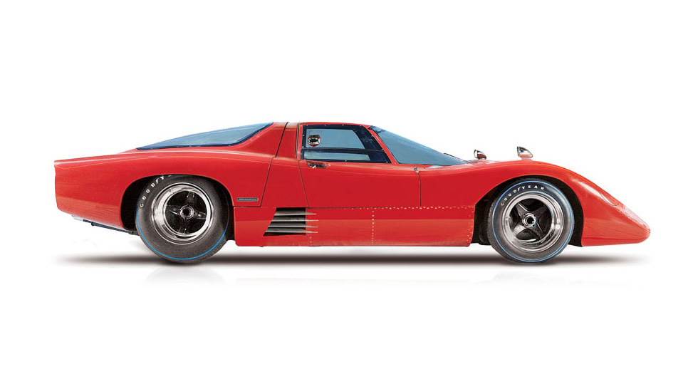 Side view of a red McLaren M6GT, on a white background.