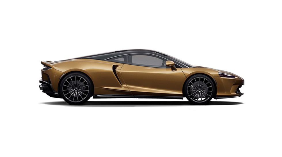 Side view of a brown McLaren GT, shown on a white background.