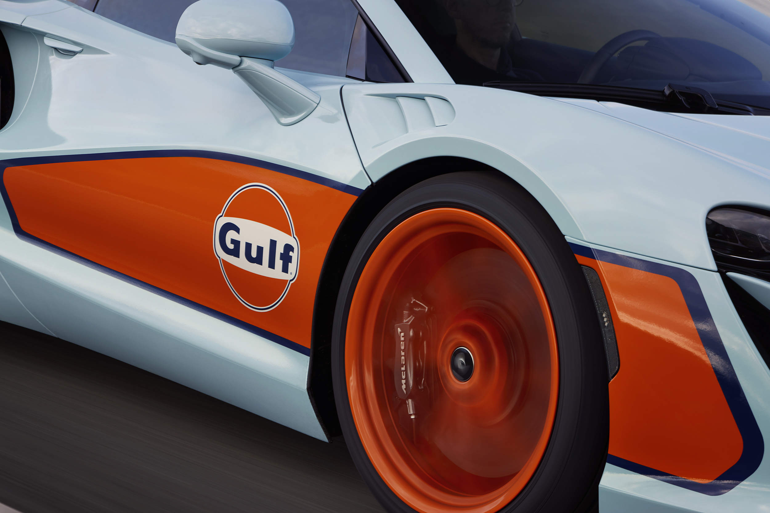 Close up of the drivers side wheel and logo on the Gulf branded McLaren.