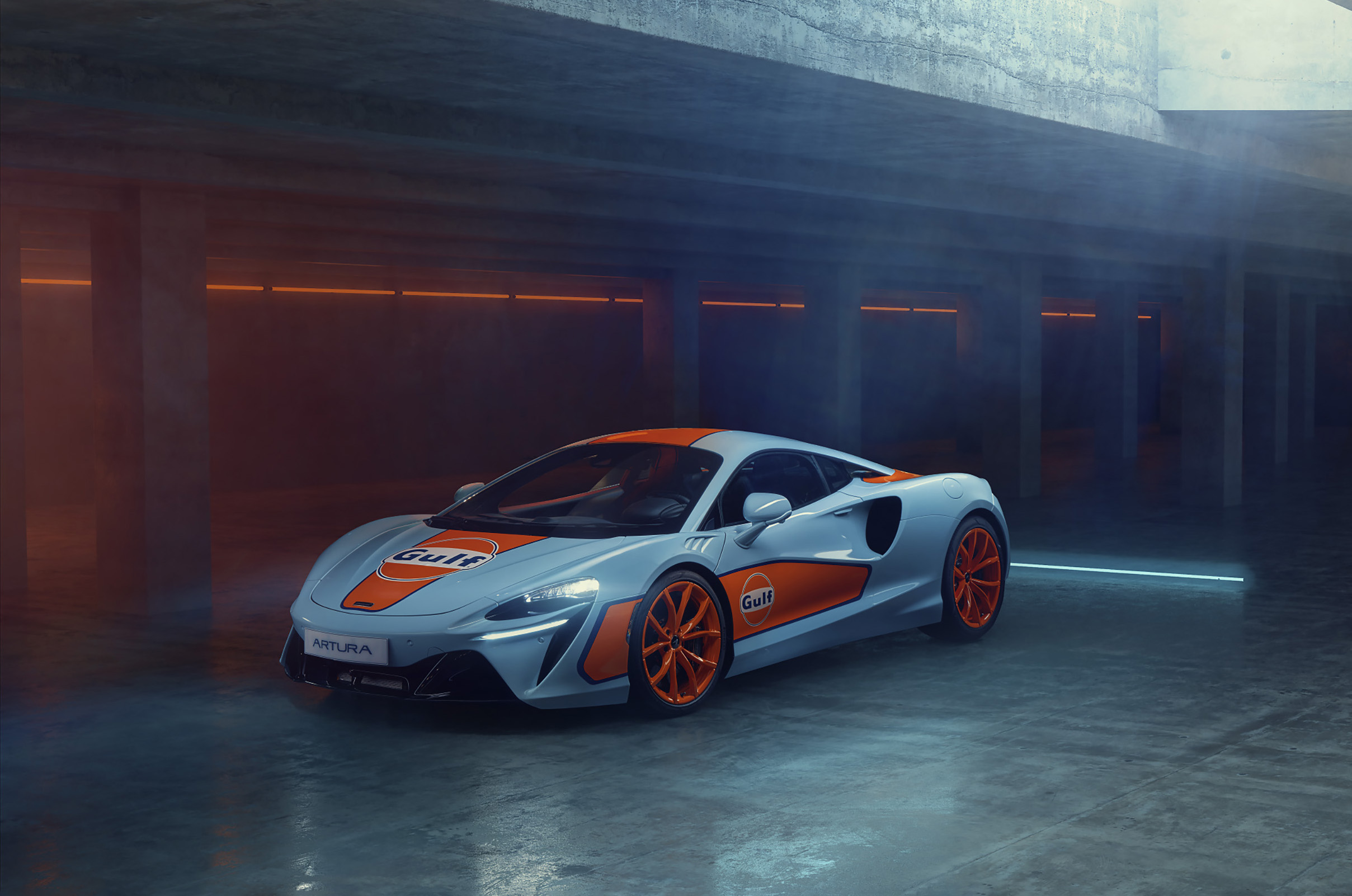 Gulf Branded McLaren parked in an underground concrete structure.