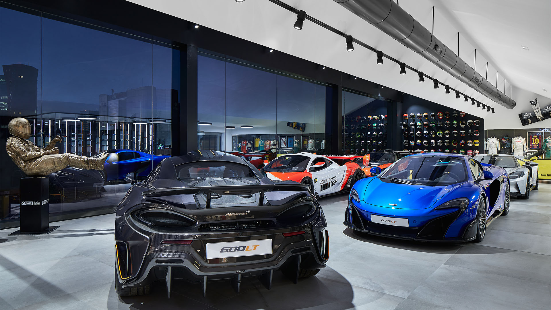 A series of McLaren cars on display inside the McLaren Barcelona showroom.