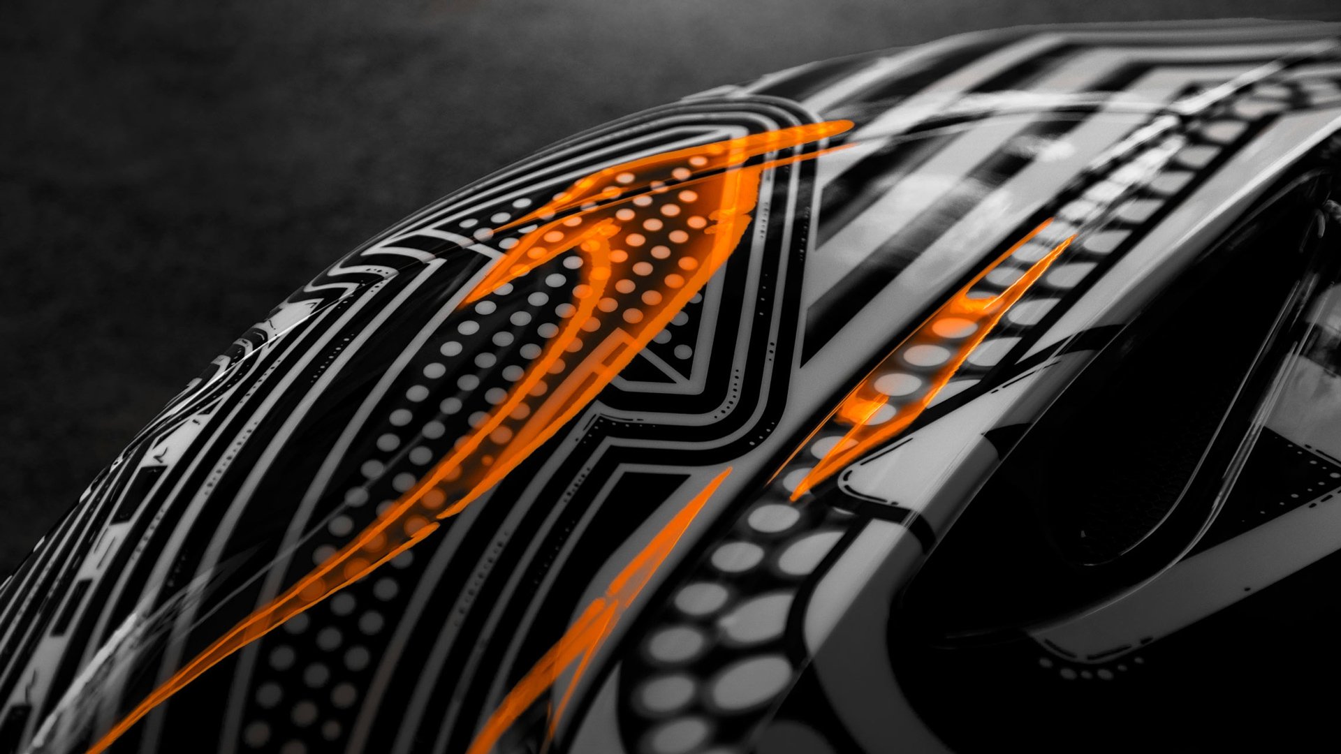 Abstract close-up of the Project Viva livery, featuring a complex pattern of black, white, and dotted circles with striking, illuminated McLaren orange accent lines on the fender.
