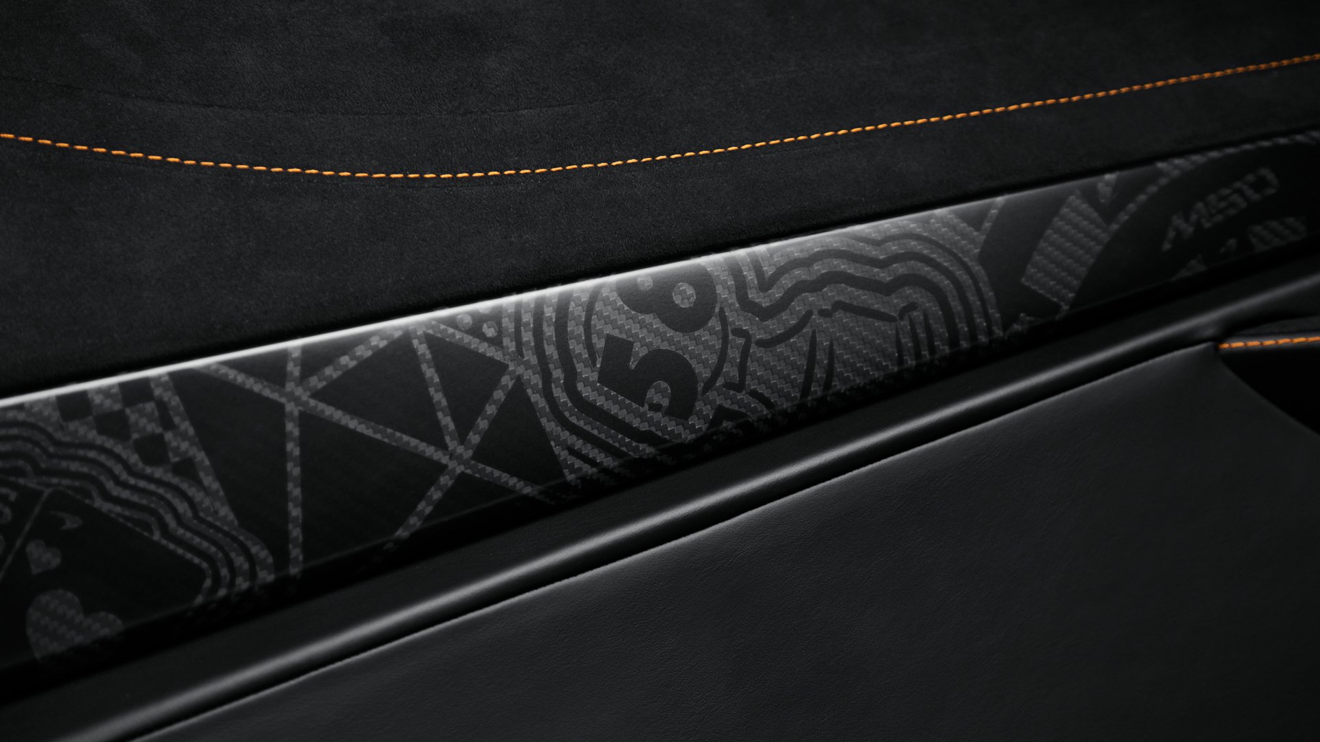Close-up of the bespoke carbon fibre trim detail in the McLaren 750S MSO interior, featuring subtle laser-etched graphics of casino themes from the Project Viva livery.