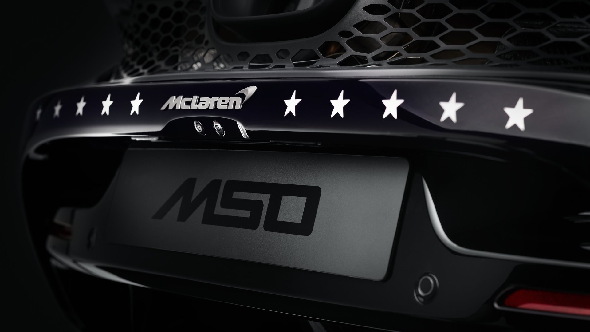 Rear detail of the MSO Project Viva showing the blacked-out MSO rear panel and a row of stars, symbolizing McLaren's championship history in the custom finish.