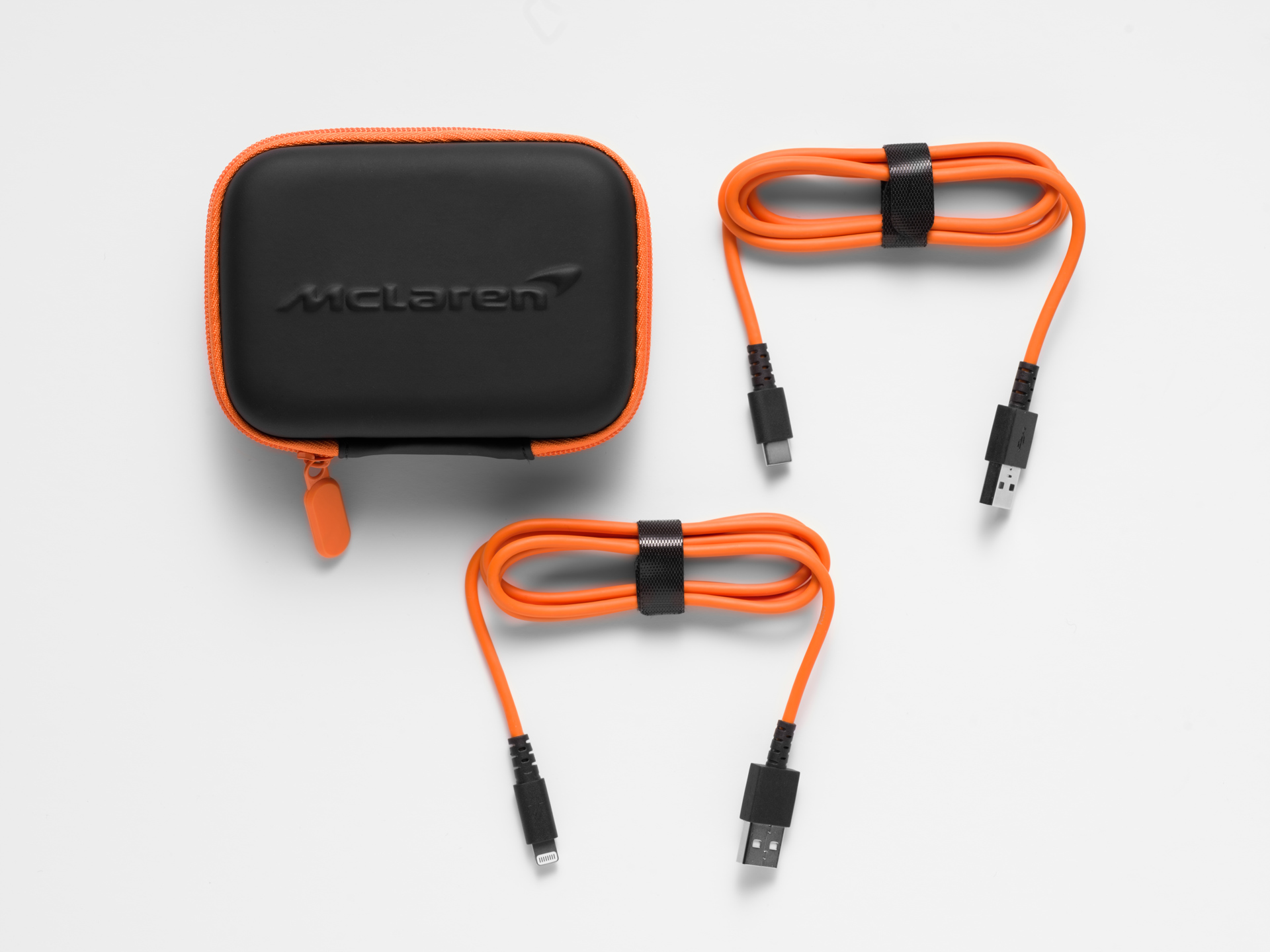McLaren USB cables placed next to a mini McLaren branded travel case.