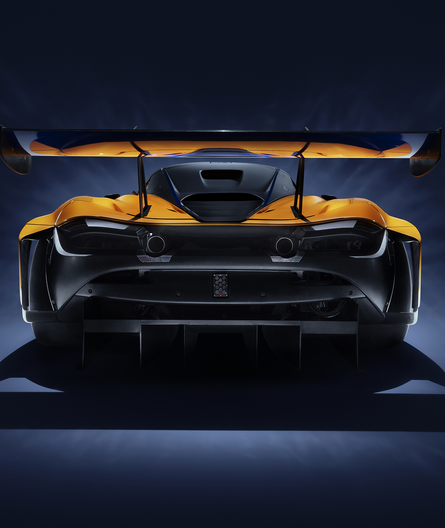 Rear view of McLaren Racing 720S GT3 photographed on a dark studio background.