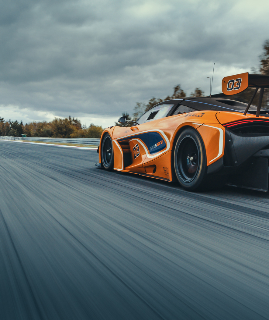 The McLaren Racing 720S GT3 driving around a race track at speed.