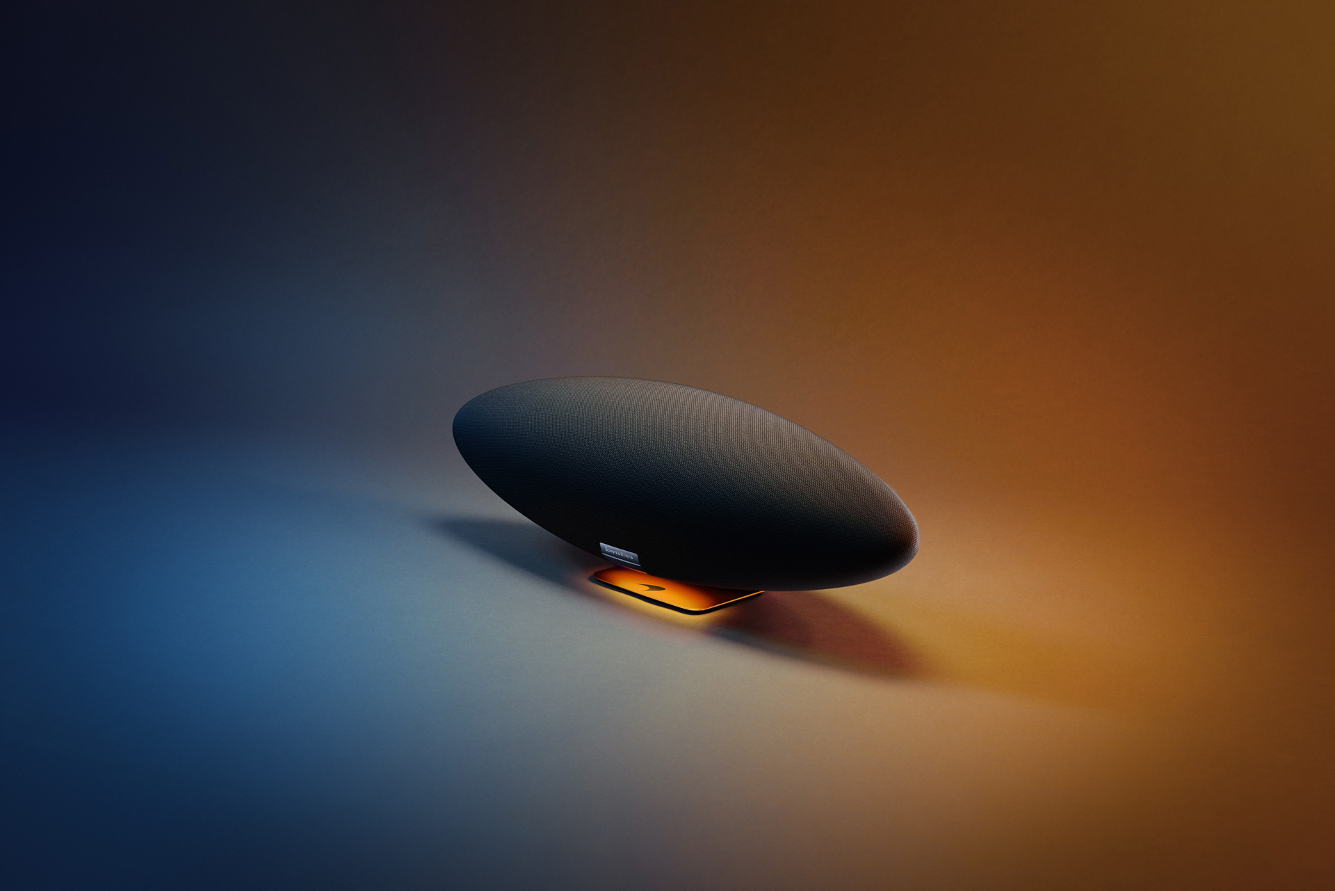 Bowers & Wilkins Zeppelin McLaren Edition speaker on a multi coloured background.